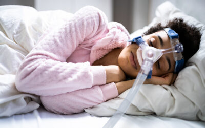 Patient using CPAP machine during sleep apnea treatment to keep airway open