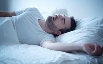 Person experiencing loud snoring and breathing pauses during sleep apnea